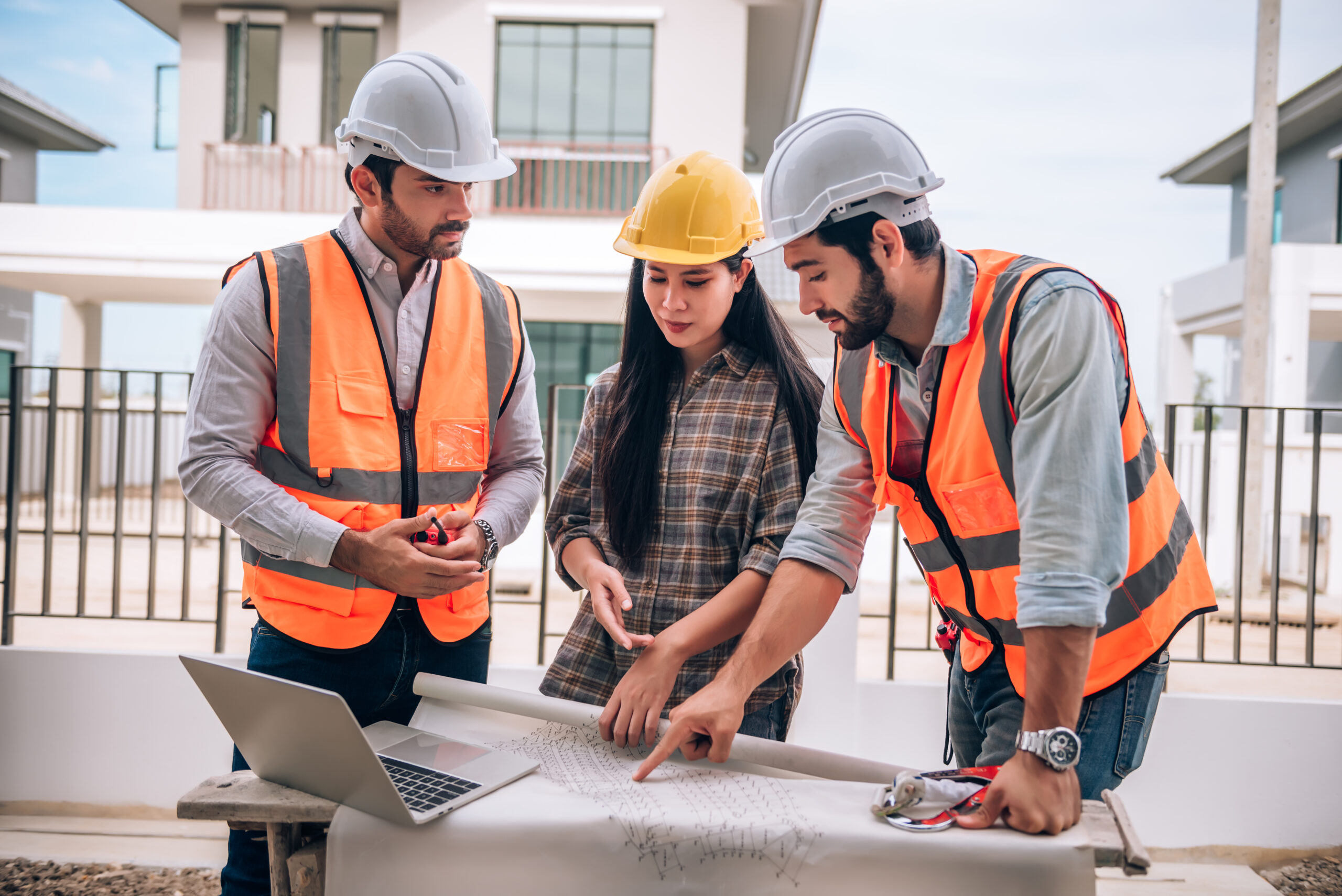 civil-engineer-construction-worker-architects-wearing-hardhats-safety-vests-are-working-together-construction-site-building-home-cooperation-teamwork-concept-scaled.jpg